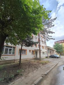 an apartment building on the corner of a street at Intime Poto House Suceava in Suceava