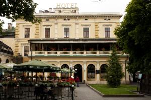 a hotel with a table in front of a building at Wien Hotel in Lviv