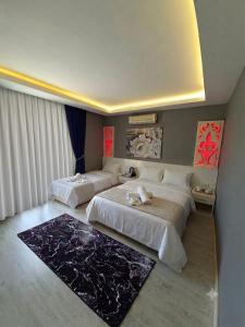 a hotel room with two beds in a room at Beachway Hotel in Side