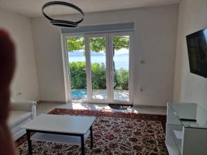 a living room with a view of the ocean at Guest House Perla in Sveti Juraj