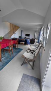 a living room with a red table and chairs at Casas do Pargo- Casa A - Oak Tree House in Lombada Velha