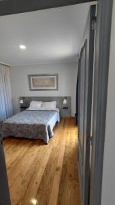 a bedroom with a bed and a wooden floor at Casas do Pargo- Casa A - Oak Tree House in Lombada Velha +57 photos