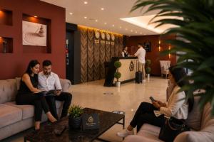 a group of people sitting on couches in a lobby at SWEET HOME SUiTE HOTEL in Trabzon