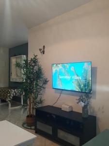 a living room with a flat screen tv on the wall at Slow Life Bouznika in Bouznika