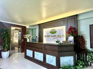 a lobby with a spa pharmacy with flowers on a counter at Hồ Sen Xanh Hotel Hà Nội in Hanoi
