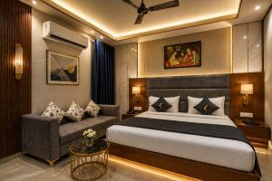 a bedroom with a bed and a couch at Hotel Eden Suites Delhi Airport in New Delhi +175 photos