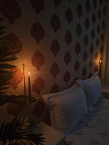 a room with a bed with a candle on the wall at Slow Life Bouznika in Bouznika +5 photos