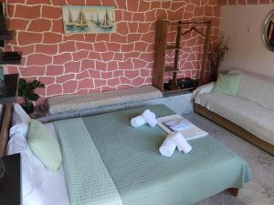 two dolls sitting on a table in a living room at The cave of Cyclops in Makri