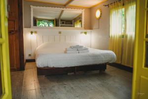 a bedroom with a bed with towels on it at La Calanque de Figuerolles in La Ciotat