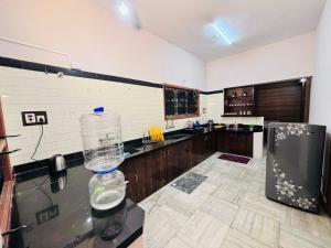 a kitchen with a bottle of water on a counter at Majestic Villa, 5 Bedroom AC in Mysore in Mysore