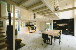 a dining room and kitchen with a table and chairs at L'Oustal des Dômes in Orcines