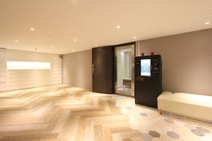 a room with a hard wood floor and a couch at Cheers Loft Self Check-in Hotel in Taipei