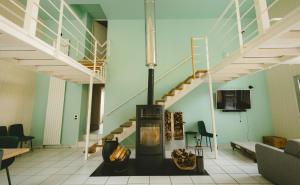 a room with a staircase and a stove in it at L'Oustal des Dômes in Orcines