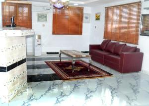 a living room with a couch and a coffee table at Wavelength Hotel and uites in Ibadan