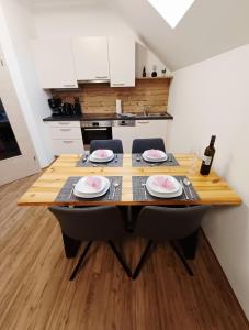 a dining room table with plates on it in a kitchen at Ferienwohnung Glashütte in Sankt Michael im Lungau