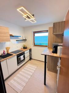 a kitchen with white cabinets and a counter top at Apartment Eppingen in Eppingen