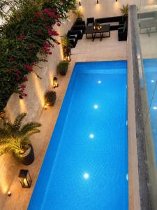 an overhead view of a blue swimming pool in a building at Riad Villa Elizabeth in Nouaseur +23 photos