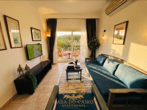 a living room with a blue couch and a table at Casa Do Cairo-Sharm Alsheikh in Sharm El Sheikh