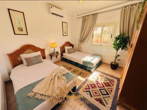 a bedroom with two beds and a window at Casa Do Cairo-Sharm Alsheikh in Sharm El Sheikh +50 photos