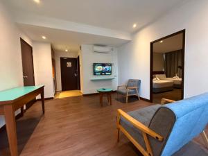 a living room with a pool table and a couch at Kingston Hotel 21 - JO Hotel Johor Bahru in Johor Bahru