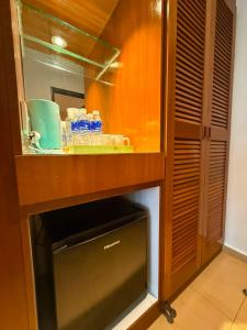 a kitchen with a counter with a sink and water bottles at Kingston Hotel 21 - JO Hotel Johor Bahru in Johor Bahru