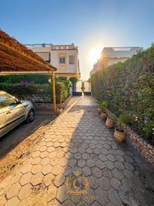 a car parked on a stone walkway next to a building at Casa Do Cairo-Sharm Alsheikh in Sharm El Sheikh