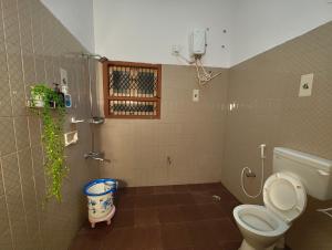 a bathroom with a toilet and a shower at Majestic Villa, 5 Bedroom AC in Mysore in Mysore +59 photos