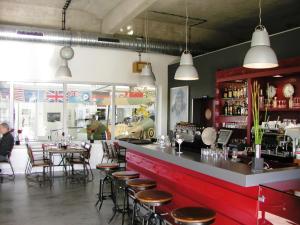 a bar in a restaurant with tables and chairs at Ferienwohnung Usedomresidenz in Ostseebad Karlshagen