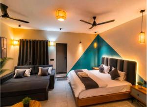 a bedroom with a bed and a couch at The Peach Boho in Mount Ābu