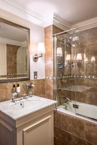 a bathroom with a sink and a shower and a tub at Crathorne Hall in Yarm