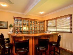 a bar in a room with chairs around it at Centurion Golf Suites Boca Walk in Centurion