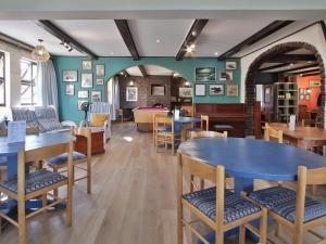 a restaurant with tables and chairs in a room at Secret Sands Glenmore Beach in Port Edward