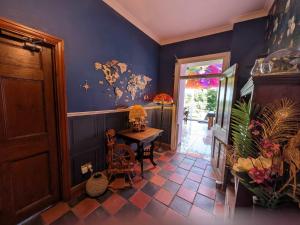 a hallway with a table and a blue wall at Farmhouse B&B Family stay or Romantic break, on our smallholding close to Narberth in Narberth +48 photos