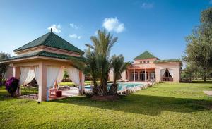 a large house with a swimming pool in a yard at Palais Alcazar in Marrakesh