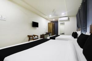 a hotel room with a bed and a tv at Townhouse RIO in Hyderabad