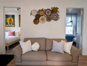 a living room with a brown couch and some pillows at Cozy and Welcoming Chalet with Spa in Saint-Tite-des-Caps +32 photos