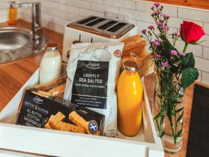 a box of food and a bottle of orange juice at Islay - Uk48416 in Dalry