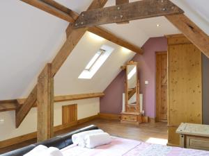 a room with a bed and wooden beams at Broad Leaf - Iok in Brandesburton +9 photos