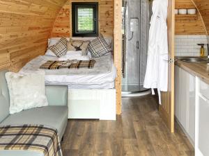 a small bedroom with a bed and a sink at Islay - Uk48416 in Dalry