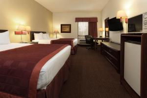 a hotel room with two beds and a flat screen tv at Baymont by Wyndham Mason in Mason