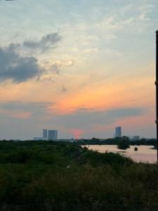 a sunset over a river with buildings in the background at Homestay PANDAN 10 PULAU MELAKA in Malacca +7 photos