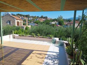 a view from the roof of a house with a patio at Olive Lemon Biophilic House & Lush Forest Garden in Vamos