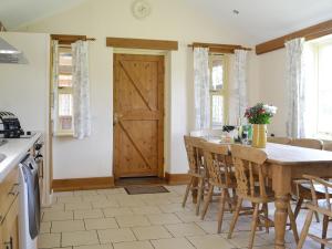 a kitchen with a table and chairs and a door at Four Bays - Ioh in Brandesburton