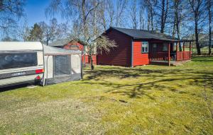 a rv parked in front of a small house at Pet Friendly Home In Slite With Kitchen in Gothem