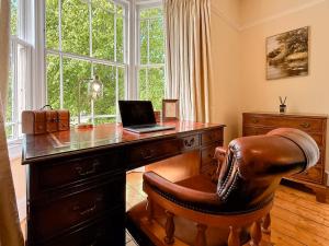 an office with a desk with a laptop and a chair at West View in Broughton