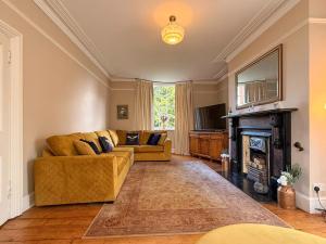 a living room with two couches and a fireplace at West View in Broughton