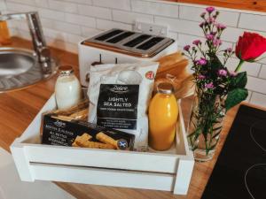 a box of food and a bottle of orange juice at Arran - Uk48415 in Dalry