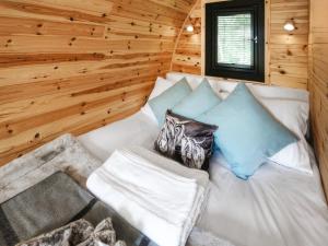 a white couch in a room with wooden walls at Arran - Uk48415 in Dalry