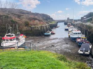 a group of boats are docked in a river at Ty Bobbet in Amlwch