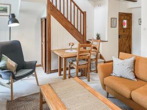 a living room with a couch and a table and chairs at Bridge Cottage - Ukc9516 in Sheepwash